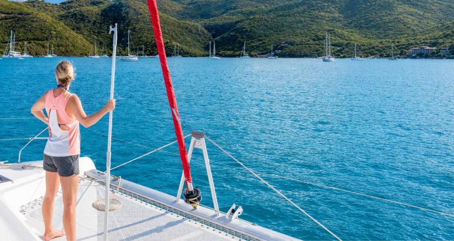 Sailor on deck approaching mooring