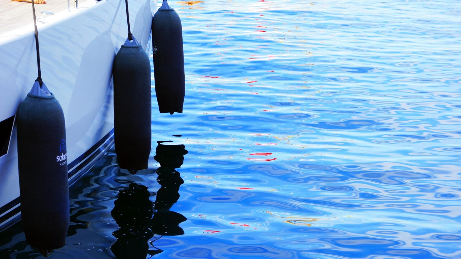 fenders hanging over the side of a sailboat
