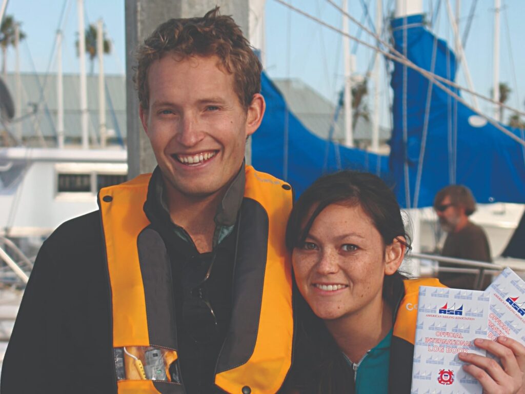 a couple smiles while displaying their ASA logbooks
